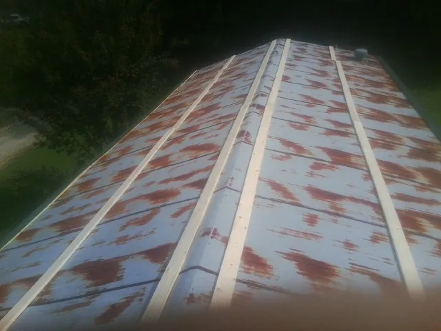 Rusted metal roof panels with new wood purlins before replacement — Storm Damage Roof Repair in Thorofare by Roofing Brothers