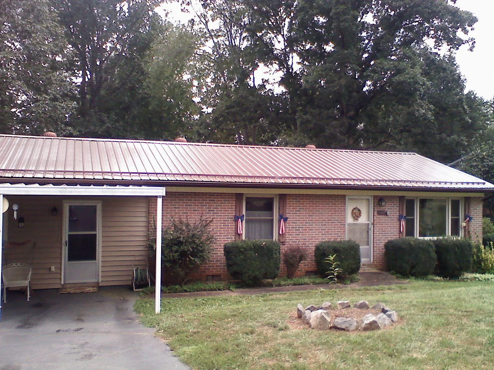 Bronze metal roof and carport on a brick ranch home — Roof Repair work by our crew in Thorofare